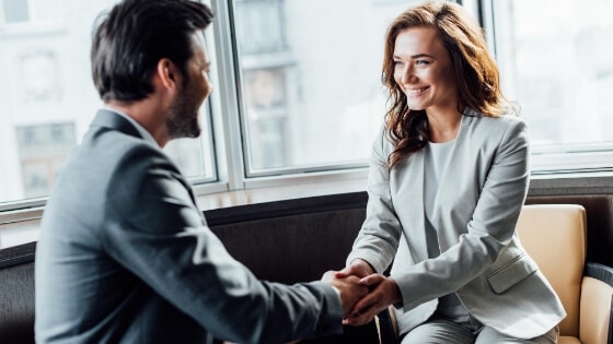 A handshake and happy faces - looks like she got a new job job!