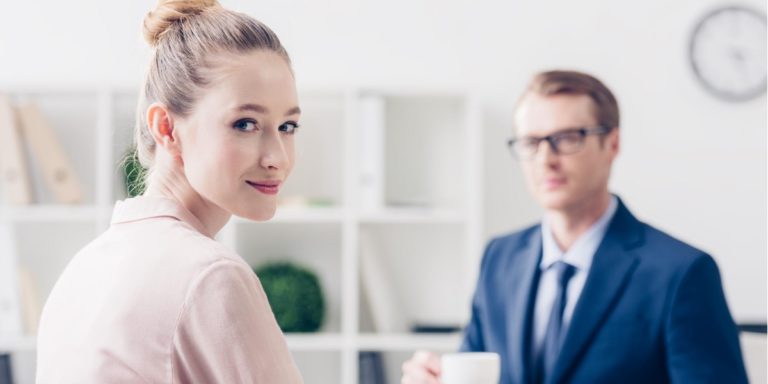 a woman and her male colleague chat about the possibility of relocating for work