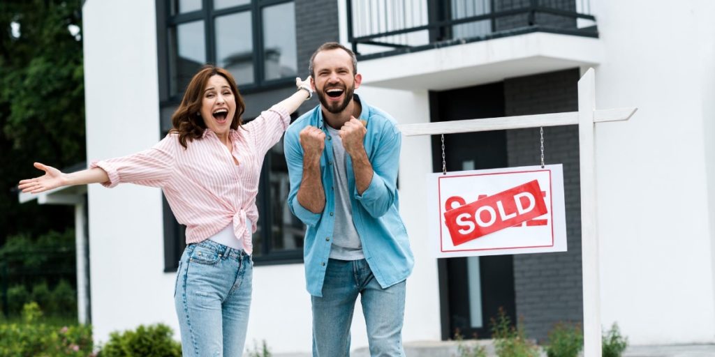 Couple looking happy after they have completed their relocation