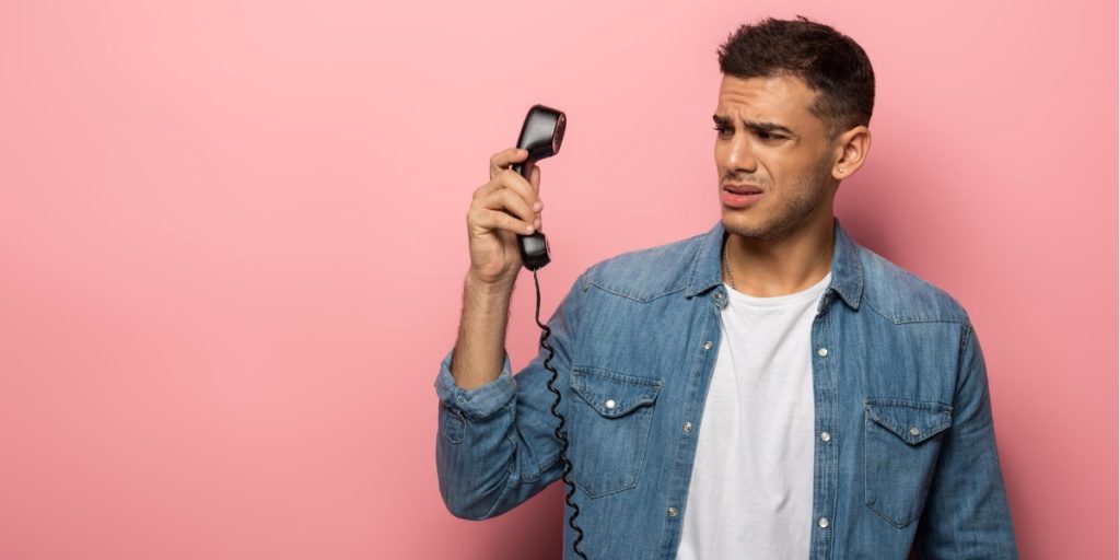 man looking panicky at the prospect of having a phone call