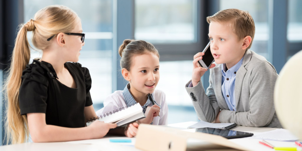 These kids mean business! Three youngsters practicing at running a business