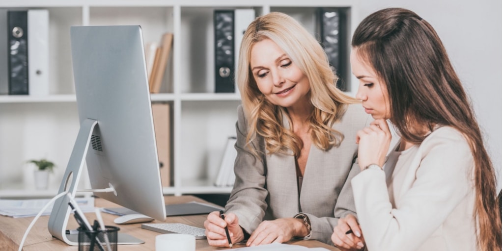 A mature lady mentoring a younger colleague