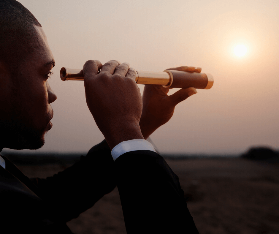 A headhunter looking for his next target with the aid of a telescope