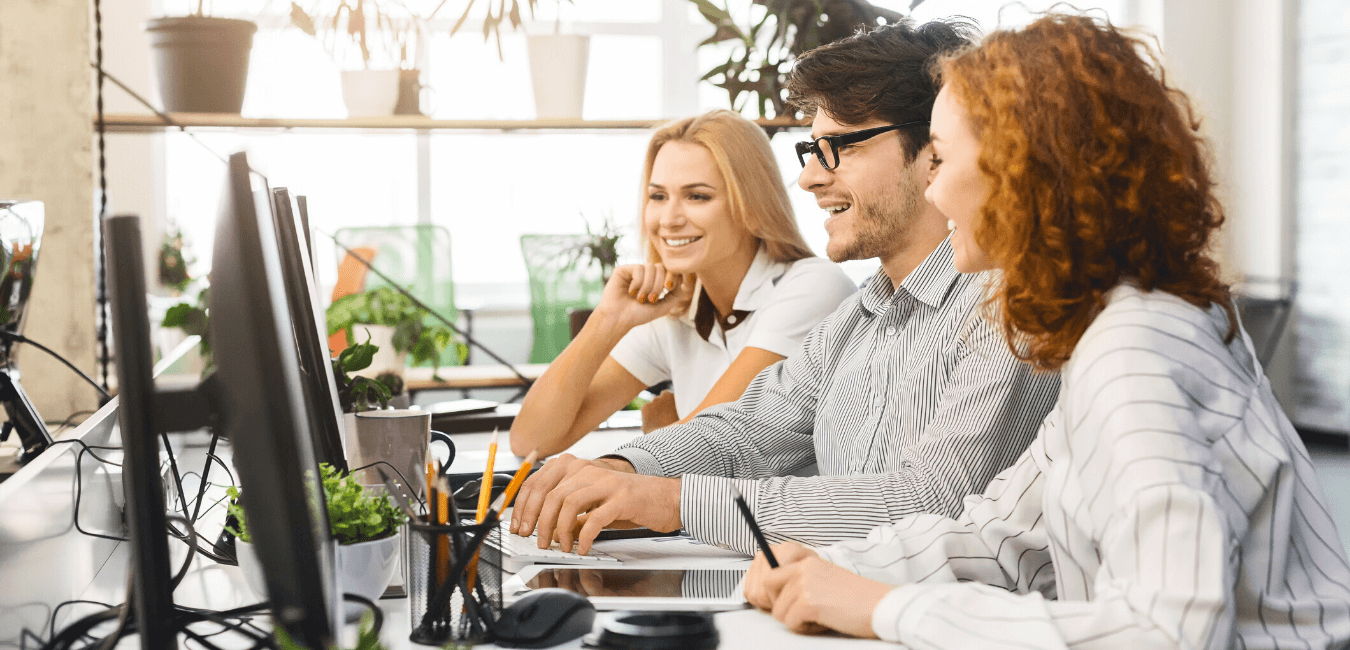 Three young business analysts enjoying their work