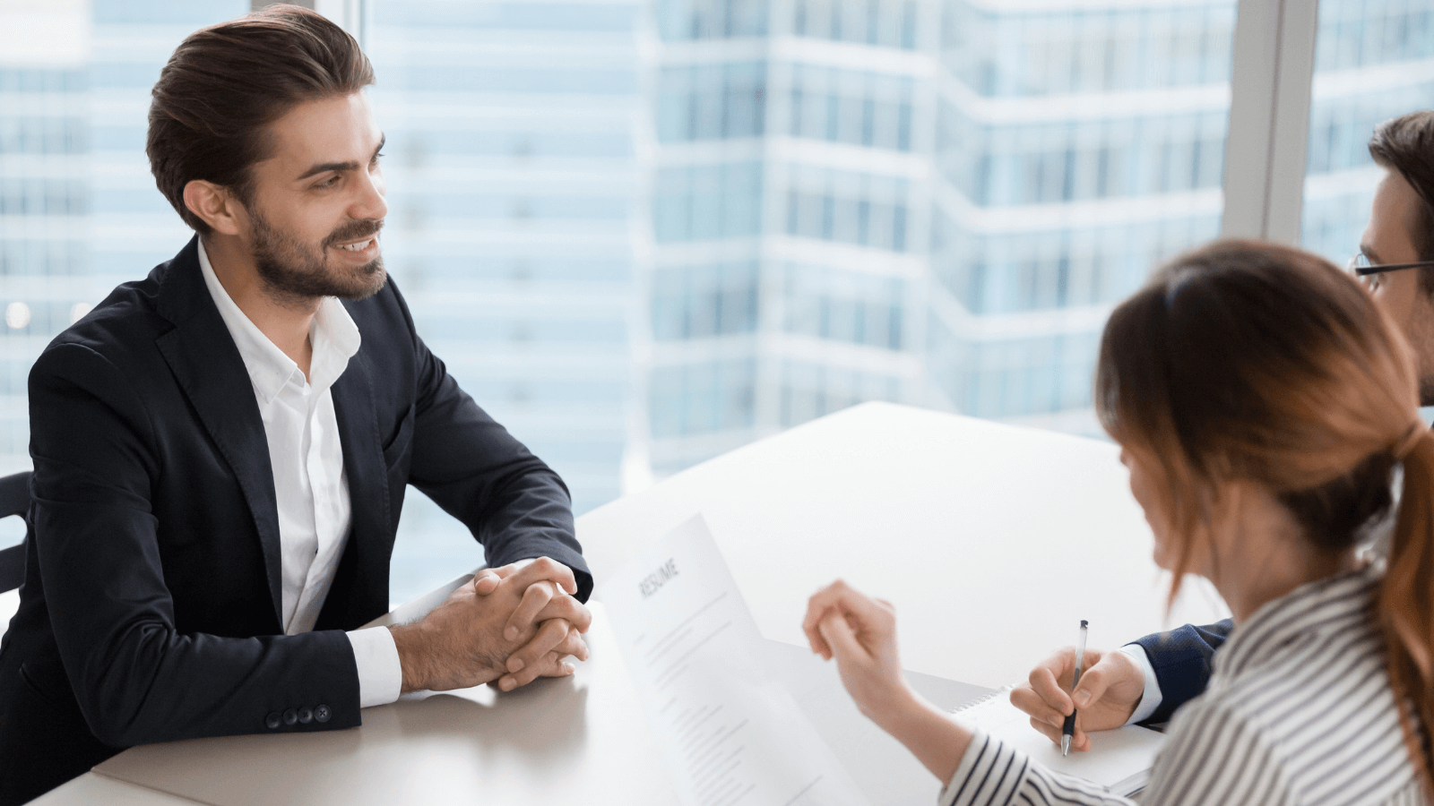 Man confidently explains the role he contributed in the success of his team.