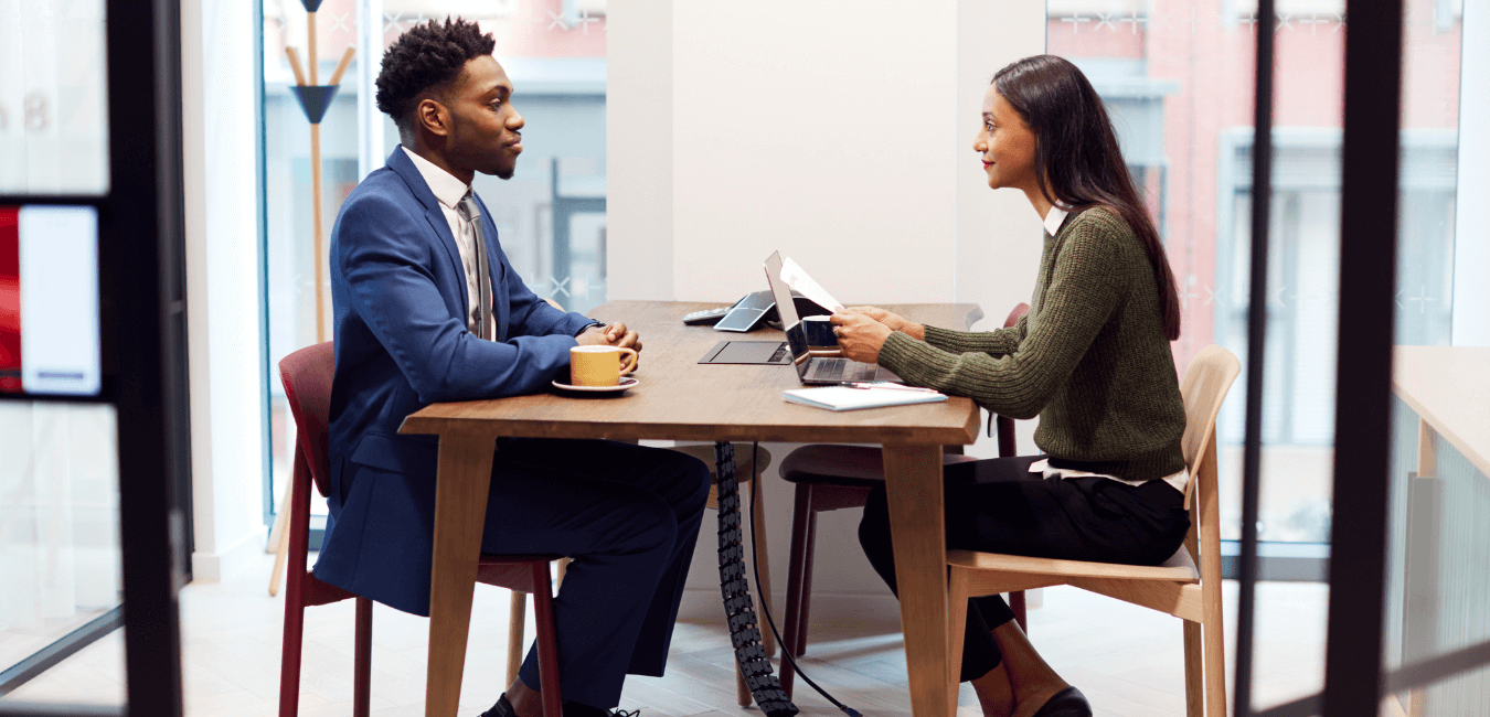 A black man is interviewed by a woman