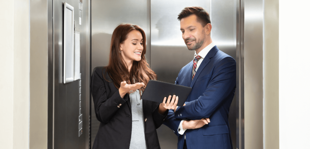 Lady delivering her elevator pitch to a senior manager