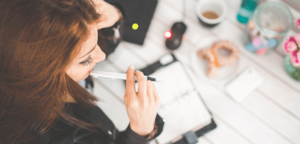 Lady reflecting after a bad experience by making a list of points to improve in her journal