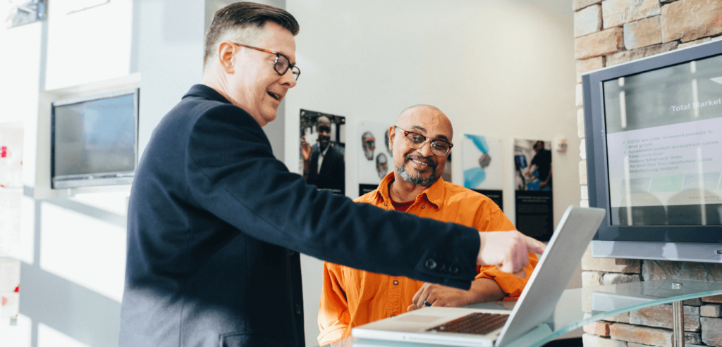 A salesman shows a customer around the features of his company's software