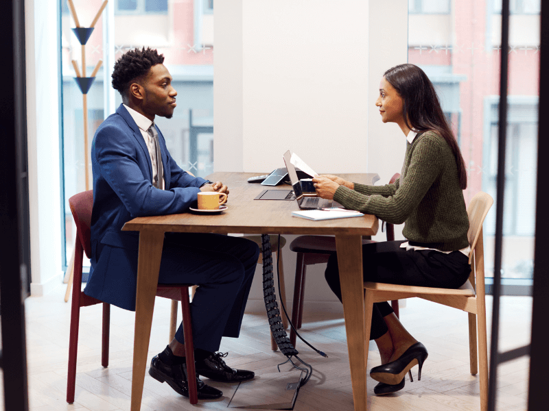 Young man having his exit interview with a member of HR