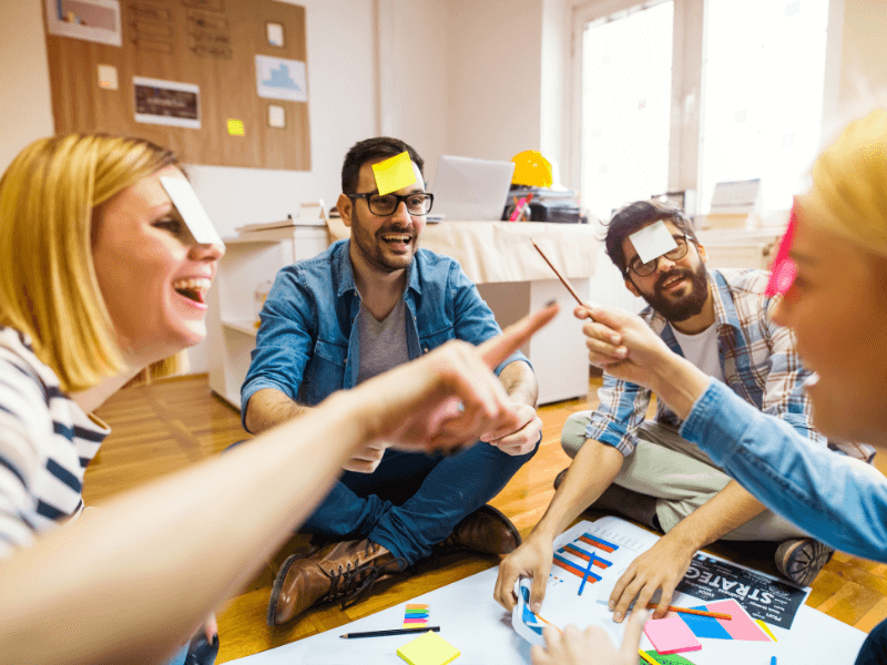 Group of people who have the most fun marketing jobs, enjoying a strategy planning session