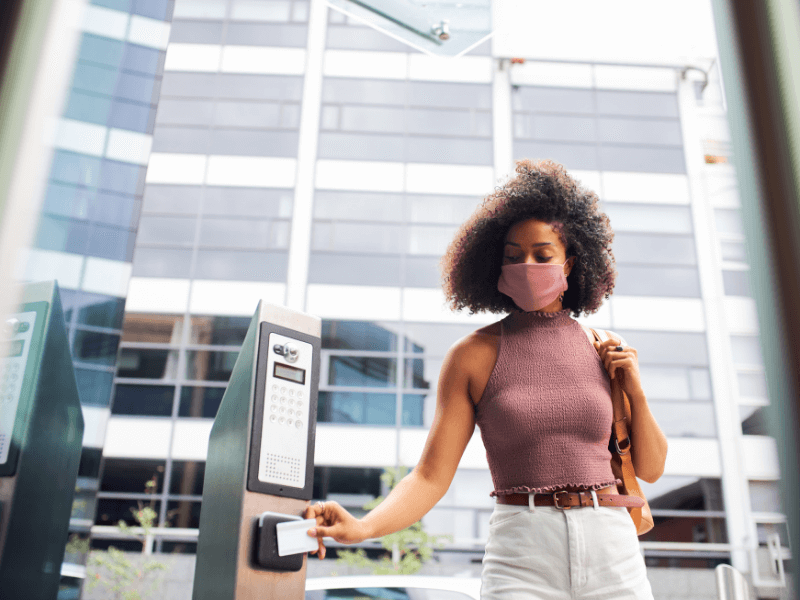 Lady using a security pass to access a building