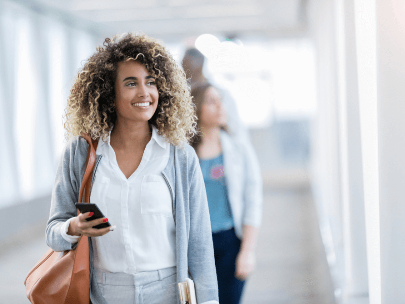 Employee with a big smile on her face as she returns to the office