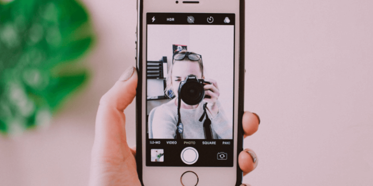 Lady taking a picture for personal branding on her iphone