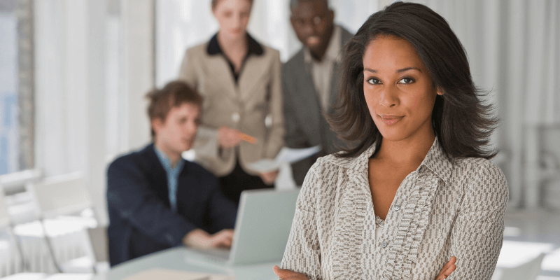 Woman standing out among her work colleagues