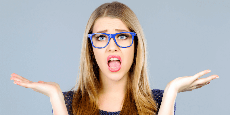 Woman shrugging her hands at a seemingly ridiculous interview question