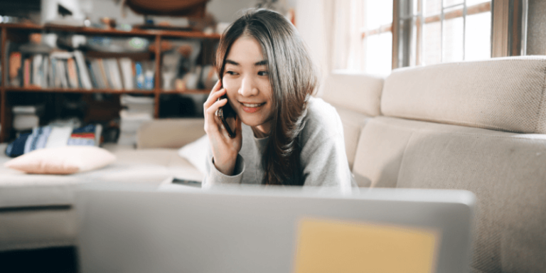 A digital marketer taking calls and sending emails while working from home