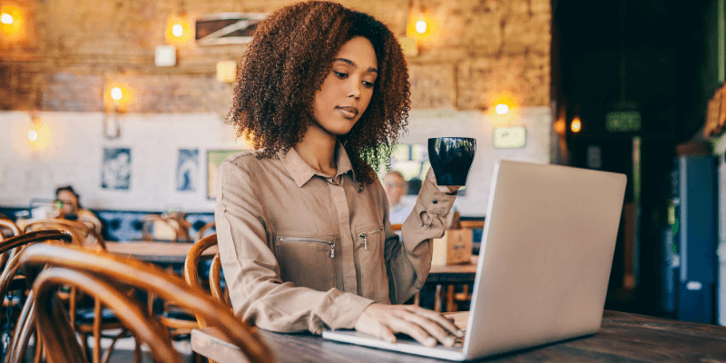 Lady looking for jobs on her laptop in a cafe