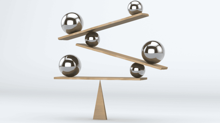 Ball bearings suspended on wooden planks represent the balance between an employer driven market and a candidate driven one