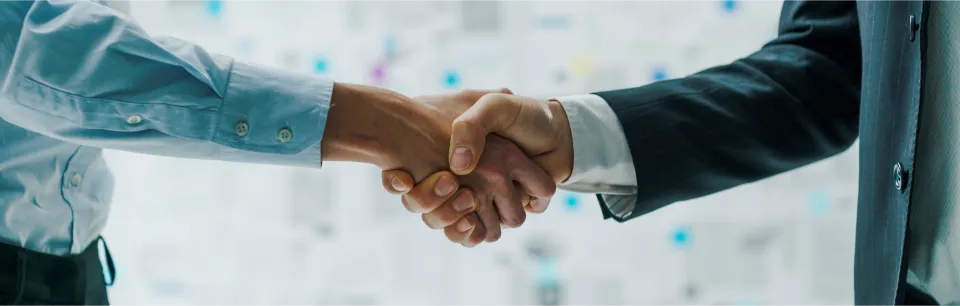 Adria's experienced recruitment consultant shake hands with a hiring manager, who has just joined Adria Talent Partnerships program to transform their company's recruitment strategy.