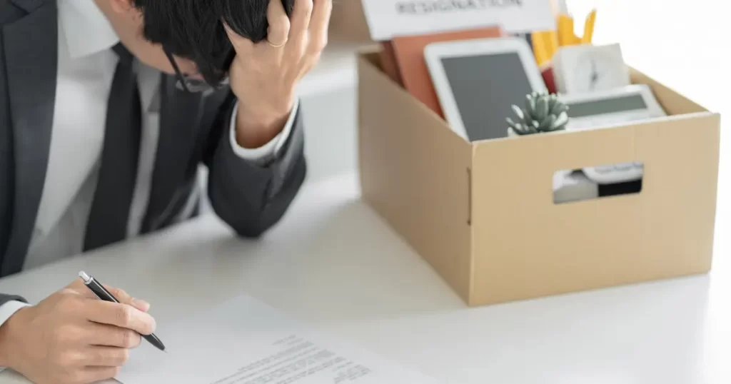 A man fills out an exit interview questionnaire after resigning from his role