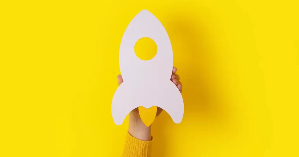 A woman holds a spaceship to symbolise speeding up and growth