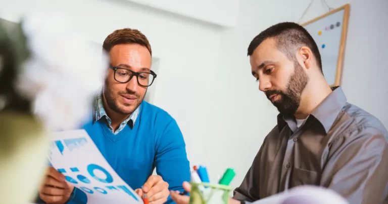 two managers discuss the different job boards they can advertise their job openings before making a decision