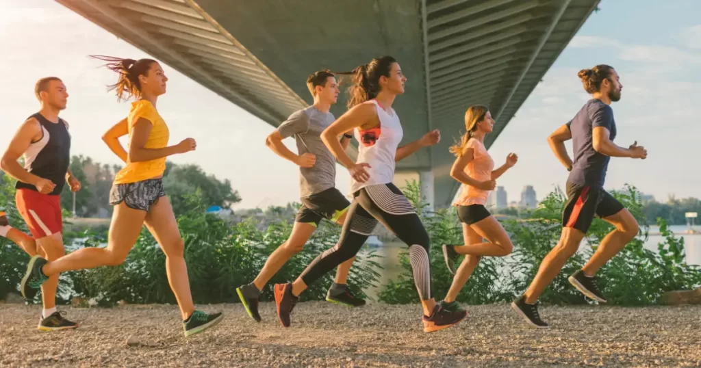 A group of professionals does jogging after work to stay healthy and take their mind off the stuff in the office