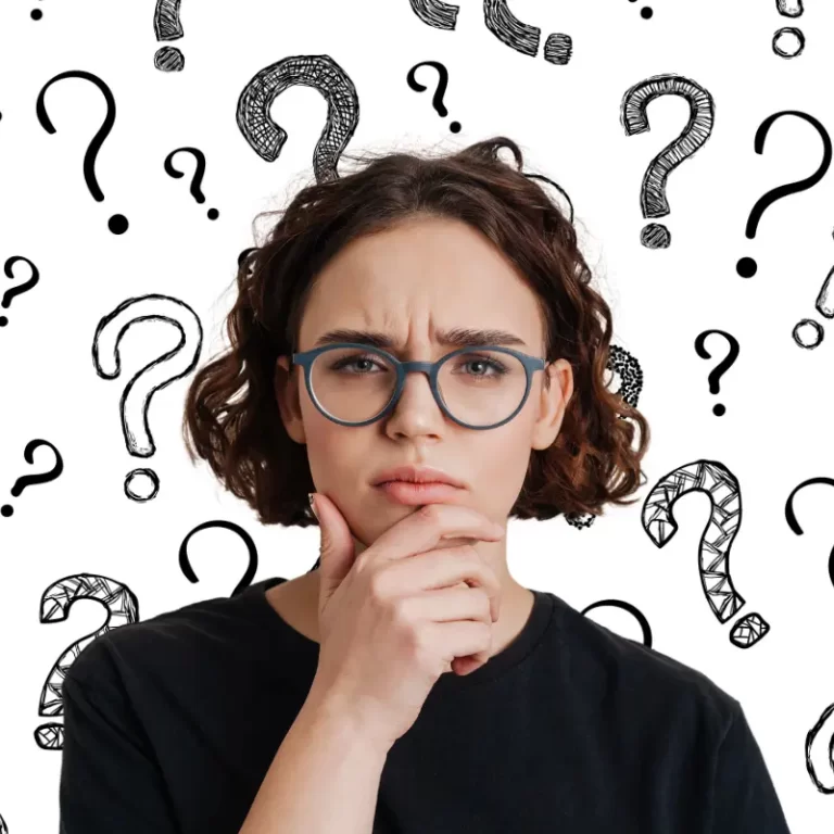 A young woman in glasses looks puzzled after her mind went blank in a job interview and she lost track of her words