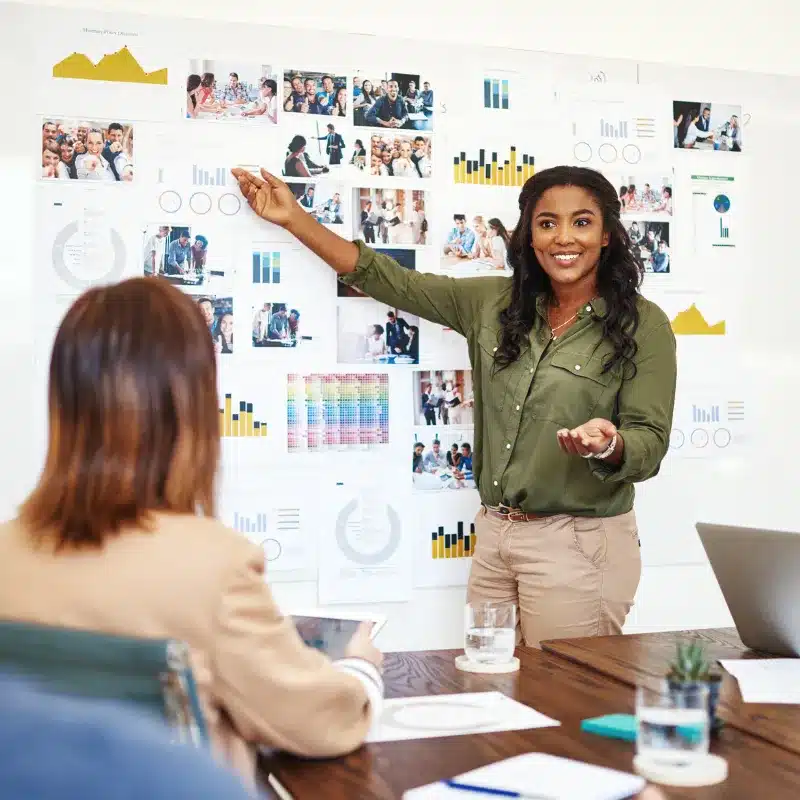 A woman briefs the Head of Marketing on her ideas for the company's branding