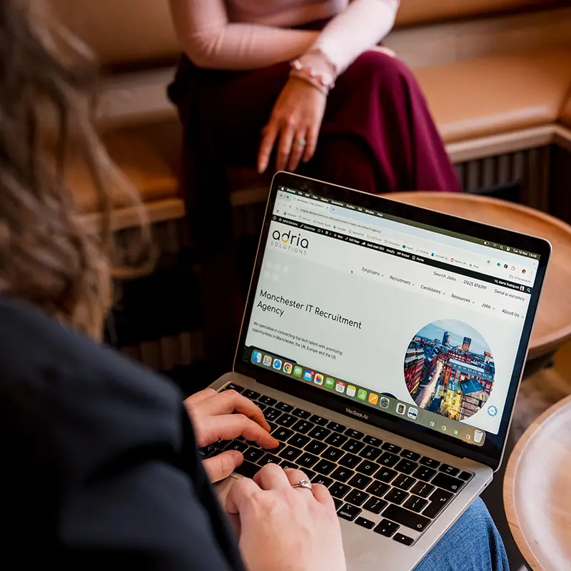 A woman checks the Adria Solutions website in her laptop, before getting in touch with Adria Solutions Recruitment agency